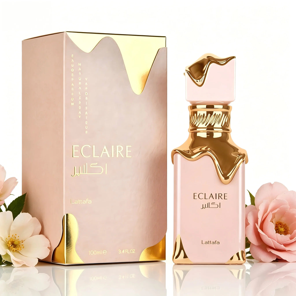 Lattafa Eclaire perfume bottle and box in soft pink with gold melted-effect trim, surrounded by delicate floral accents.