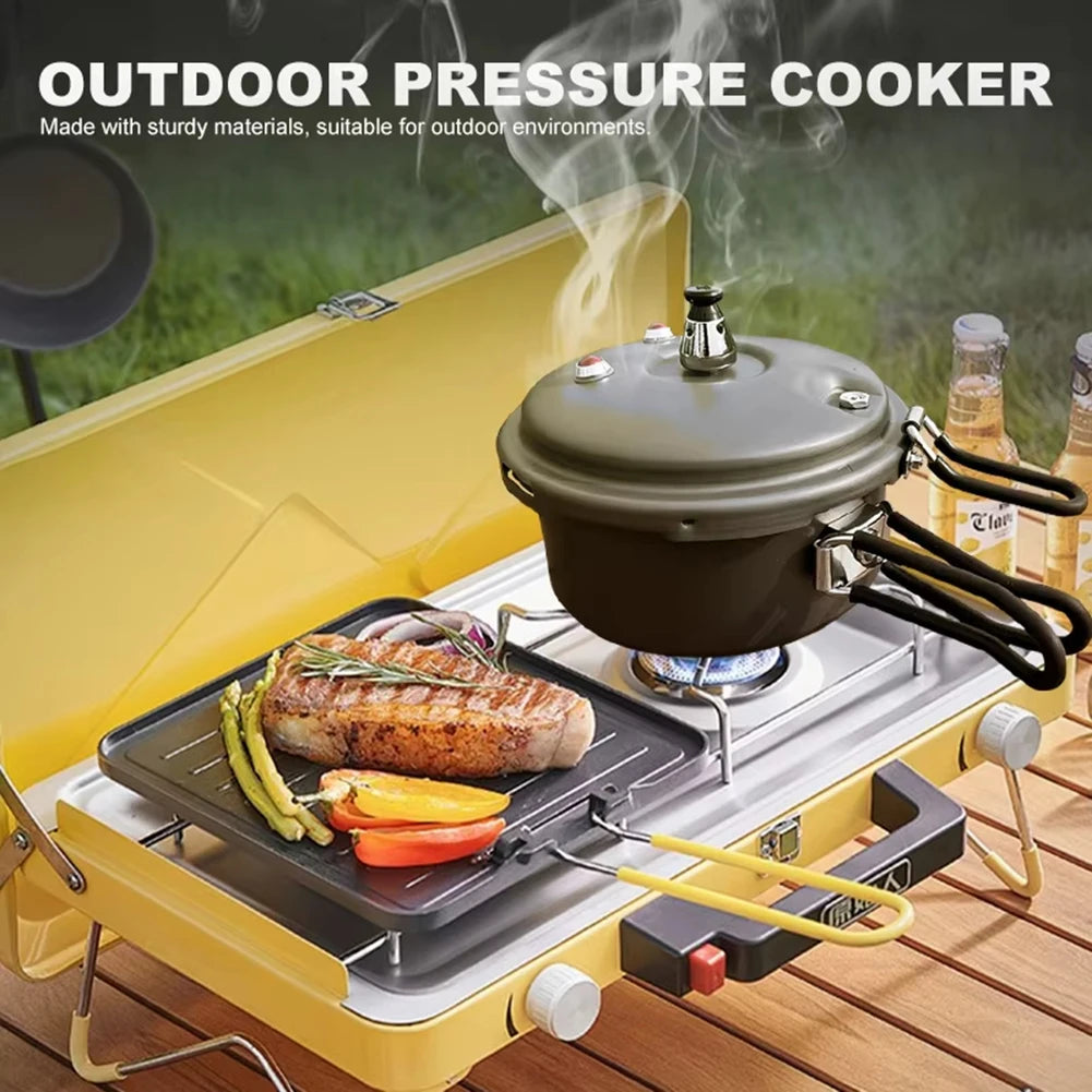 Gray pressure cooker with domed lid and folded handles cooking on portable grill
