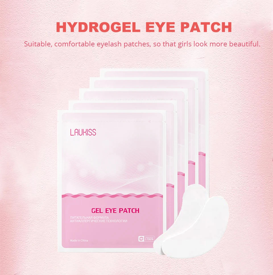 Pink Laukiss hydrogel eyelash patches in individual packets, with white adhesive under-eye pads for lash extensions.