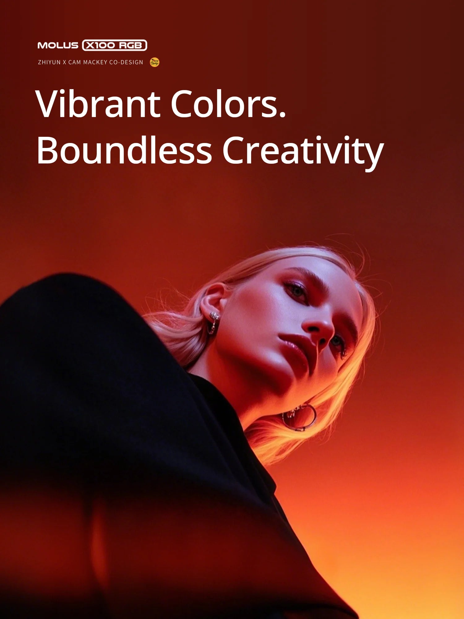 Molus X100 RGB compact LED light illuminating a woman’s face with vibrant orange and red tones for creative photography.