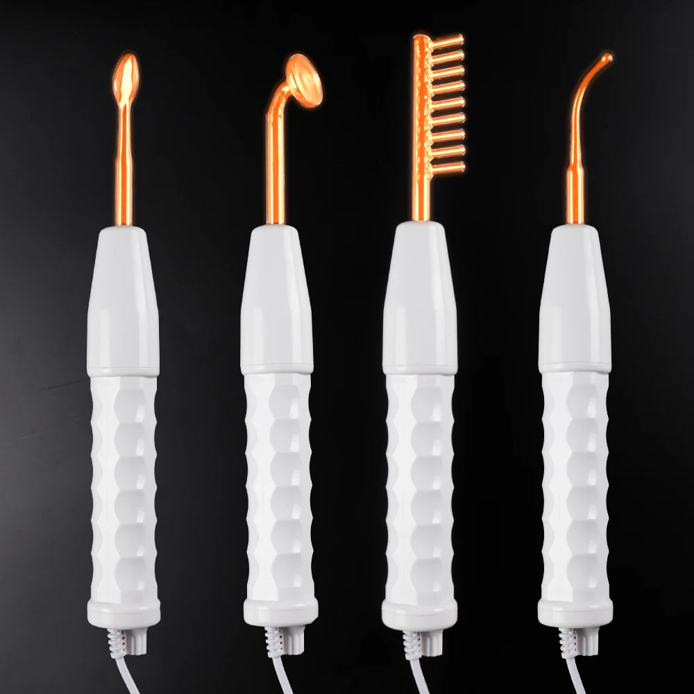 Four white high-frequency facial wands with orange glass electrodes in mushroom, comb, tongue, and bent shapes.