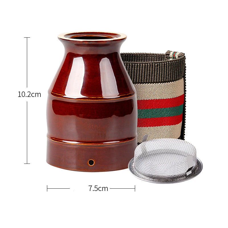 Brown ceramic moxibustion cup with a metal mesh filter and a patterned strap, measuring 10.2cm high and 7.5cm wide.