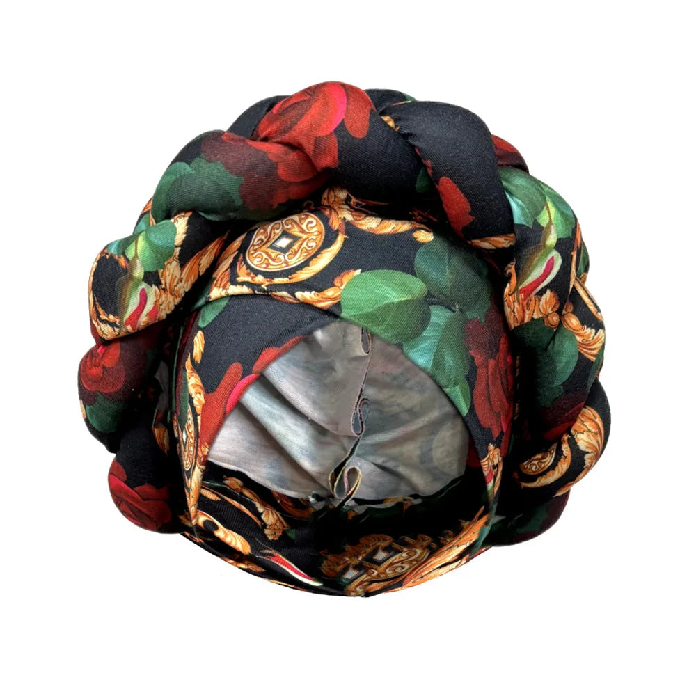 Tidesmit black turban with red roses and gold baroque pattern, featuring a thick, braided crown design.