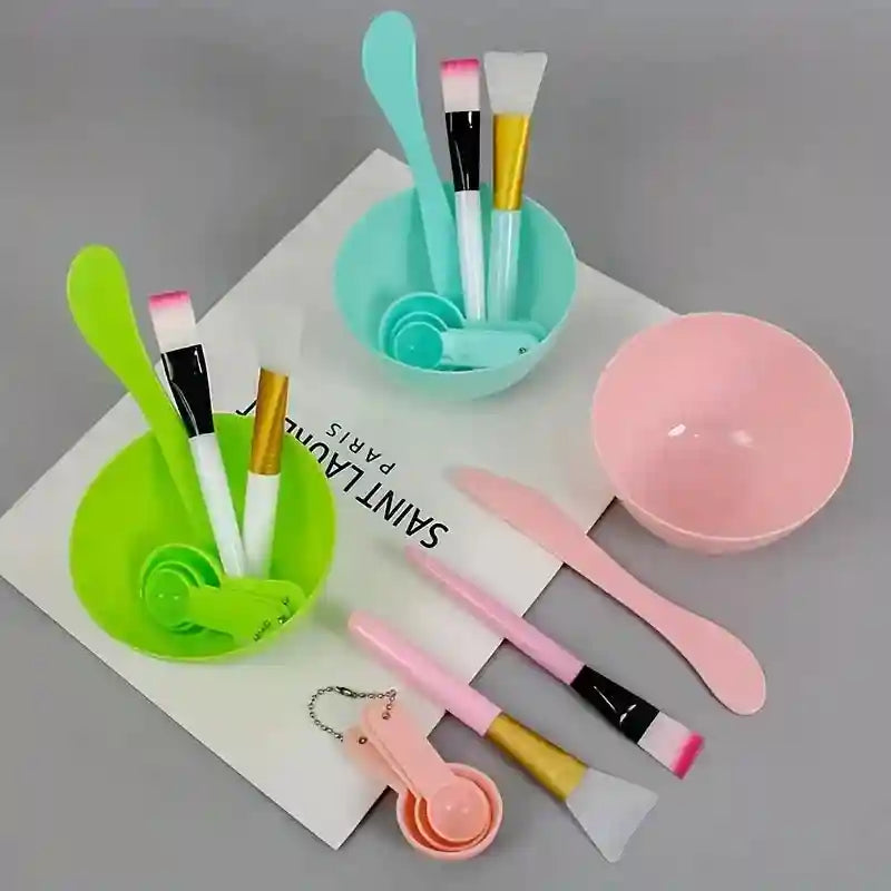 7-piece DIY face mask tool kit with pastel green, mint, and pink bowls, spatulas, brushes, and measuring spoons.