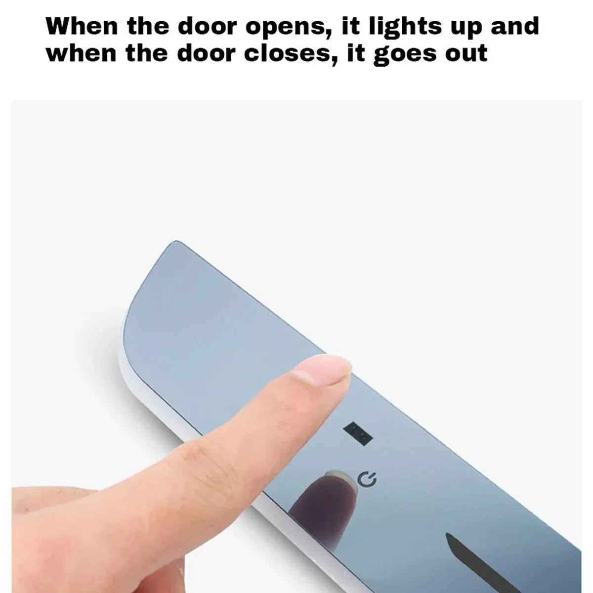 Slim metallic motion sensor light with a power button for automatic cabinet or door illumination.
