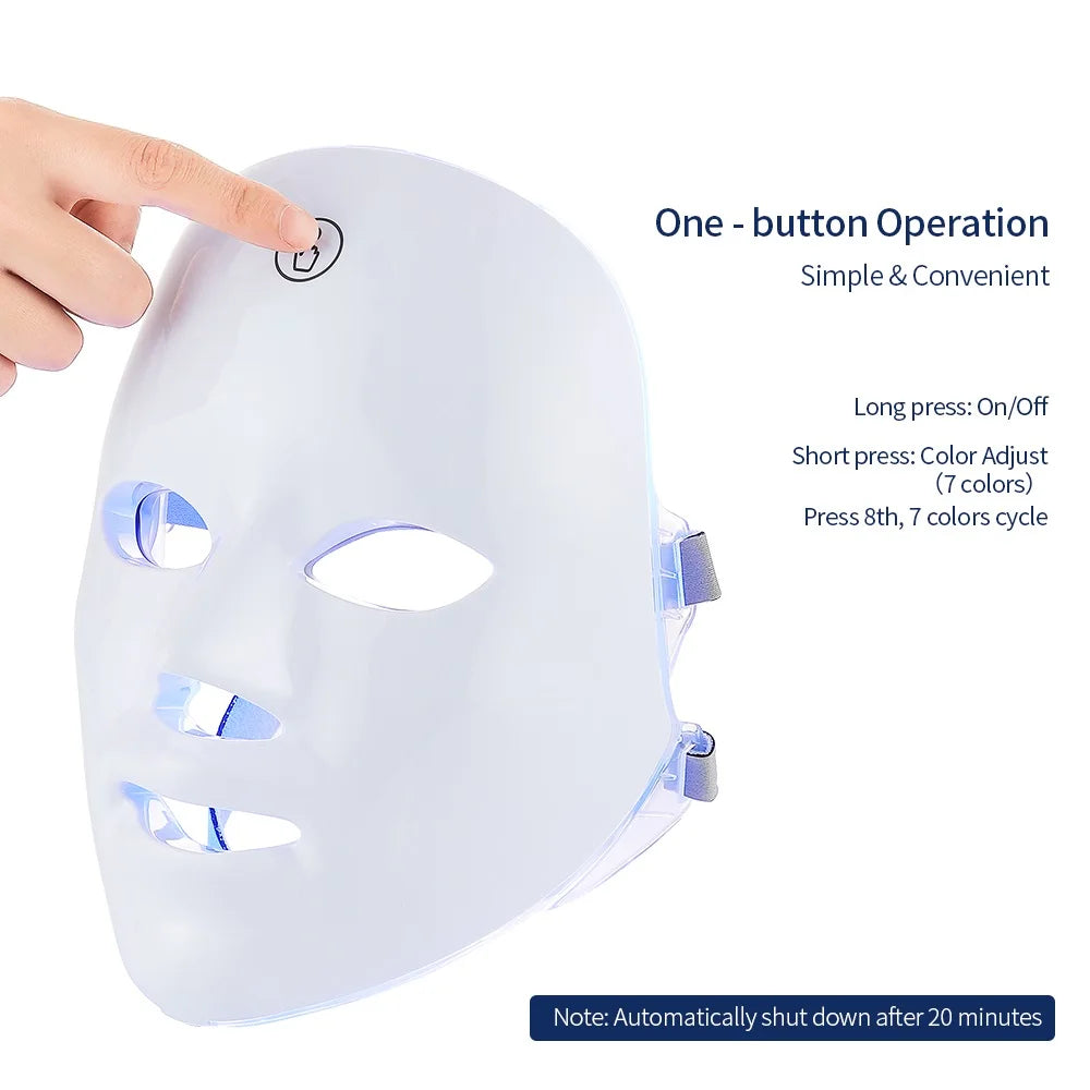 A glossy white, ergonomic LED face mask for skincare, shown with a finger pressing the single control button.