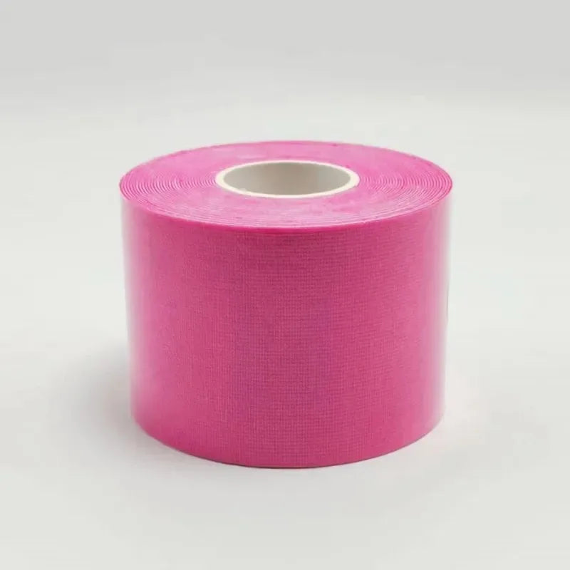 A roll of bright pink cotton kinesiology face lifting tape on a plain white background.