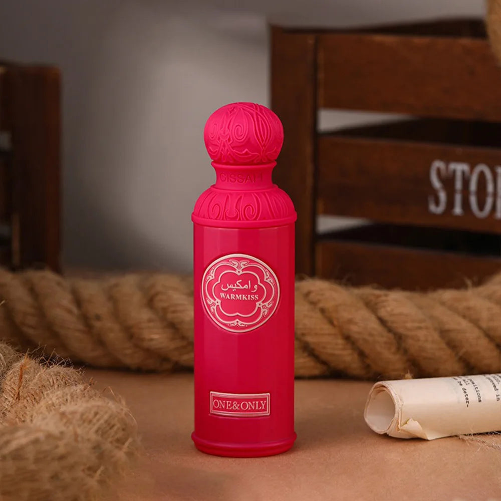 Gissah Warmkiss Unisex Eau De Parfum, 100ml long-lasting Arabian oud perfume in a vibrant pink cylindrical bottle.