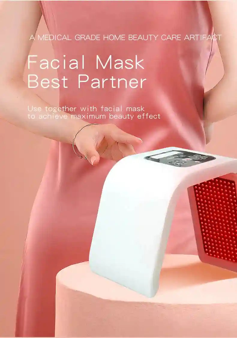 White arch-shaped LED facial light therapy device with a control panel and glowing red light panel on a pink surface.