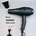 Black 2600W professional hair dryer with nozzle attachment, high-speed motor, and faceted design for quick styling.