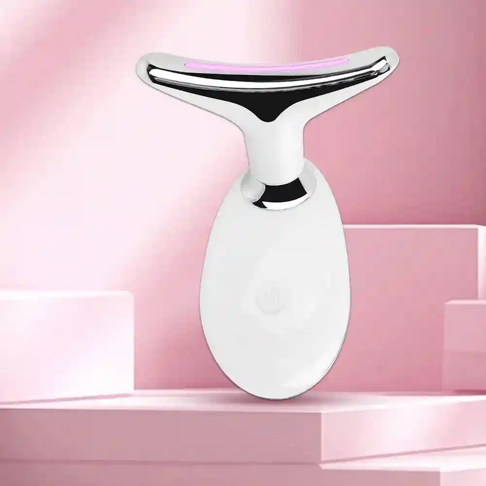 White and chrome T-shaped facial massager with a pink LED light strip on a pink geometric background.