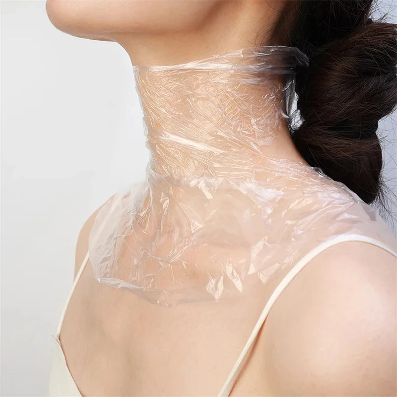 Clear, disposable plastic film wrapped around a person's neck for facial skin care treatments.