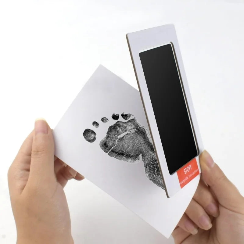 Non-toxic, inkless ink pad kit for safe newborn baby or pet paw print souvenirs on white card.