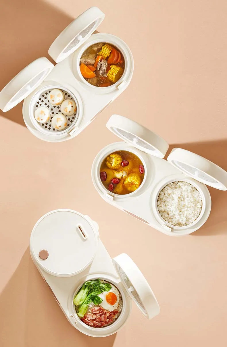 White double rice cooker with three open compartments showing different dishes