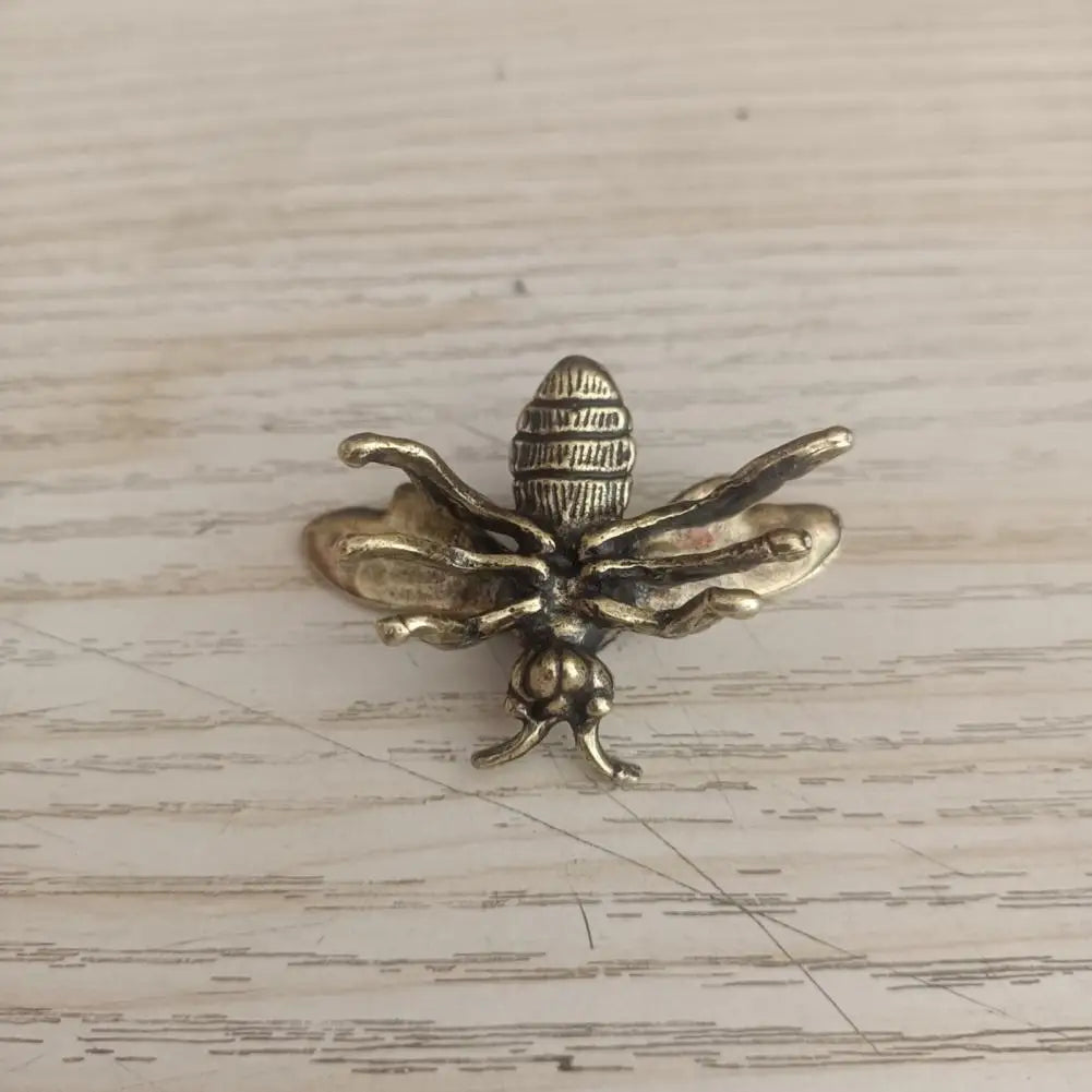 Small solid brass bee tea pet figurine, detailed golden metal sculpture for desk decor or collectible insect display.