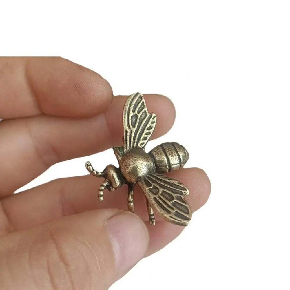 Small solid brass bee figurine, realistic golden metal insect sculpture for desktop decor or tea pet collection.