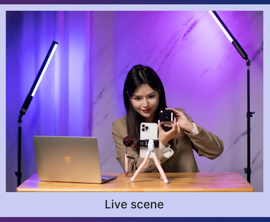 Small black square wireless microphone held by a woman filming a product demonstration on a smartphone tripod.