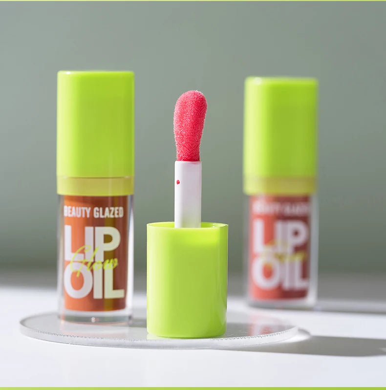Beauty Glazed moisturizing candy lip oil with a neon green cap and soft applicator for a lustrous mirror-shine finish.