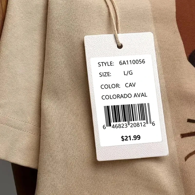 Beige garment tag with white barcode label sticker showing style, size, and price