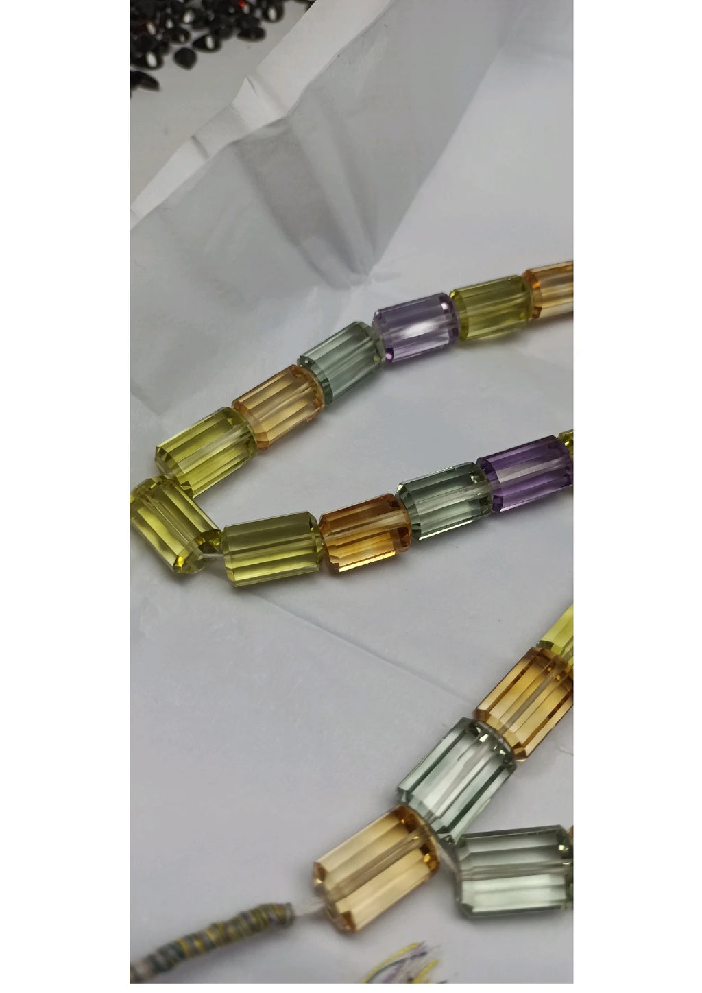 Multi-color faceted cylinder bead strand, yellow, green, and lavender beads with metal caps