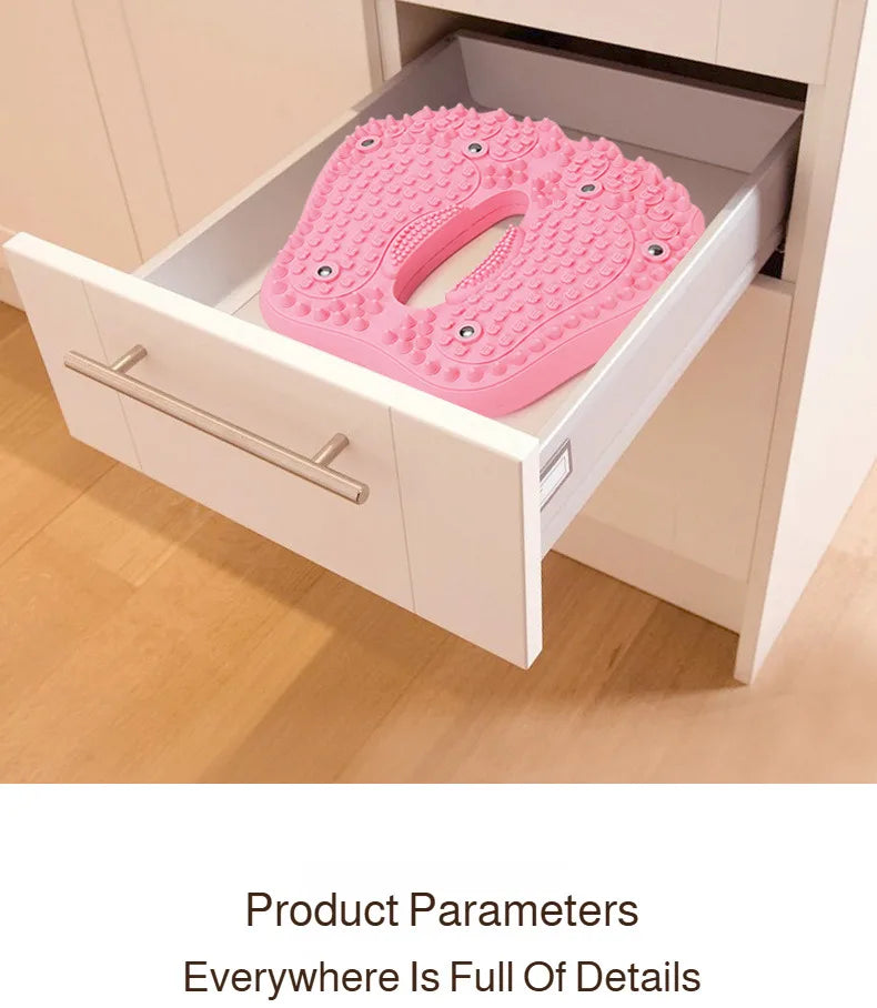 Pink, foot-shaped acupoint massage mat with magnetic accents, resting inside an open white cabinet drawer.