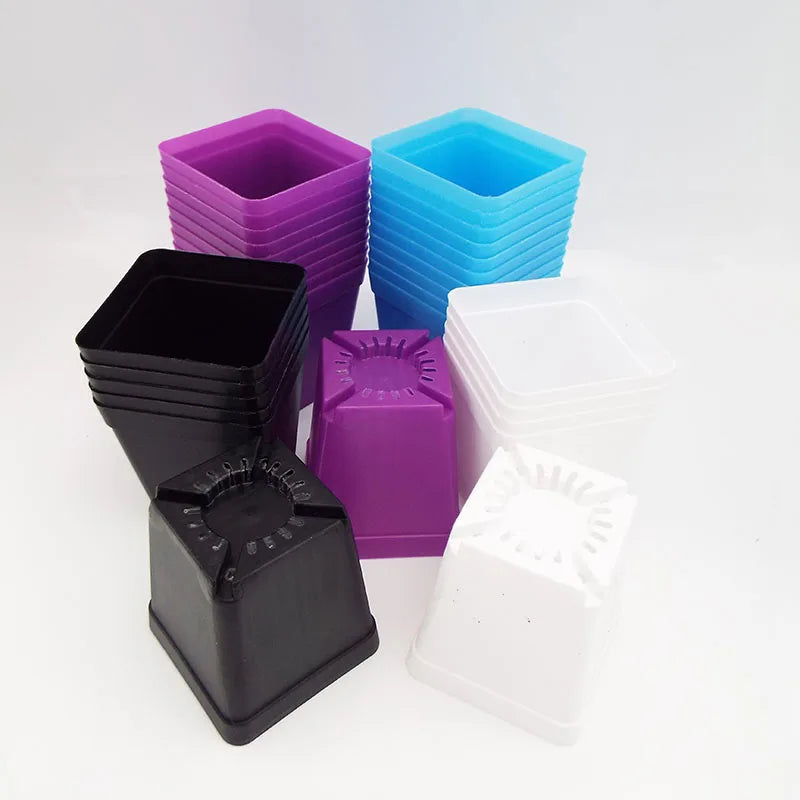 Small square plastic mini pots for succulents in black, purple, blue, and white, stacked.