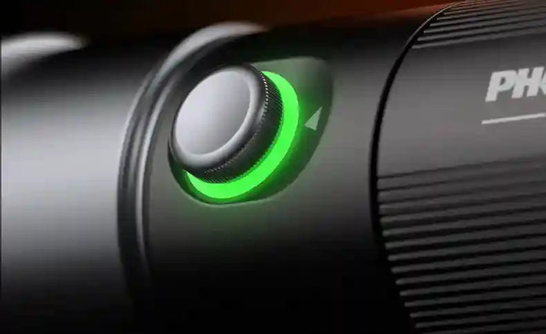 Matte black cylindrical metal dial with a glowing green LED light ring for adjustable device control settings.