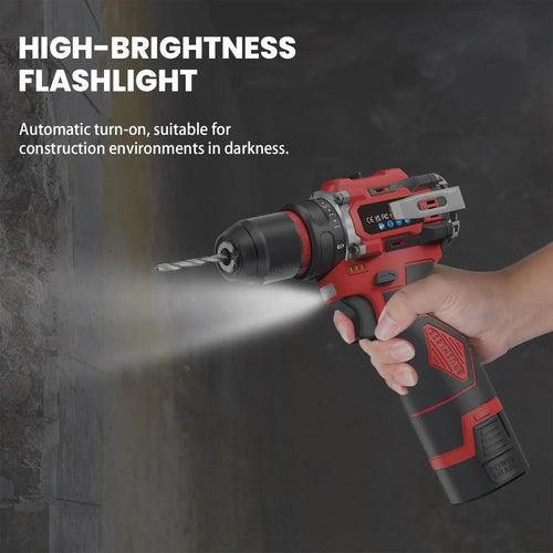 Red and black cordless impact drill held in hand, LED light illuminating a wall while drilling