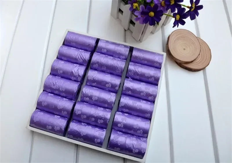 Purple leak-proof dog poop bags with cute paw prints for easy, mess-free pet waste cleanup.