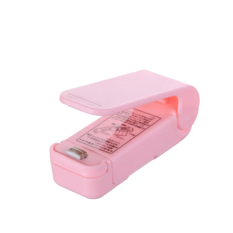 Pink mini vacuum sealer machine with open lid and sealing strip