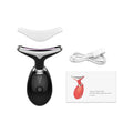 Black EMS facial massager with a curved head, white protective cover, USB cable, and product manual on white background.