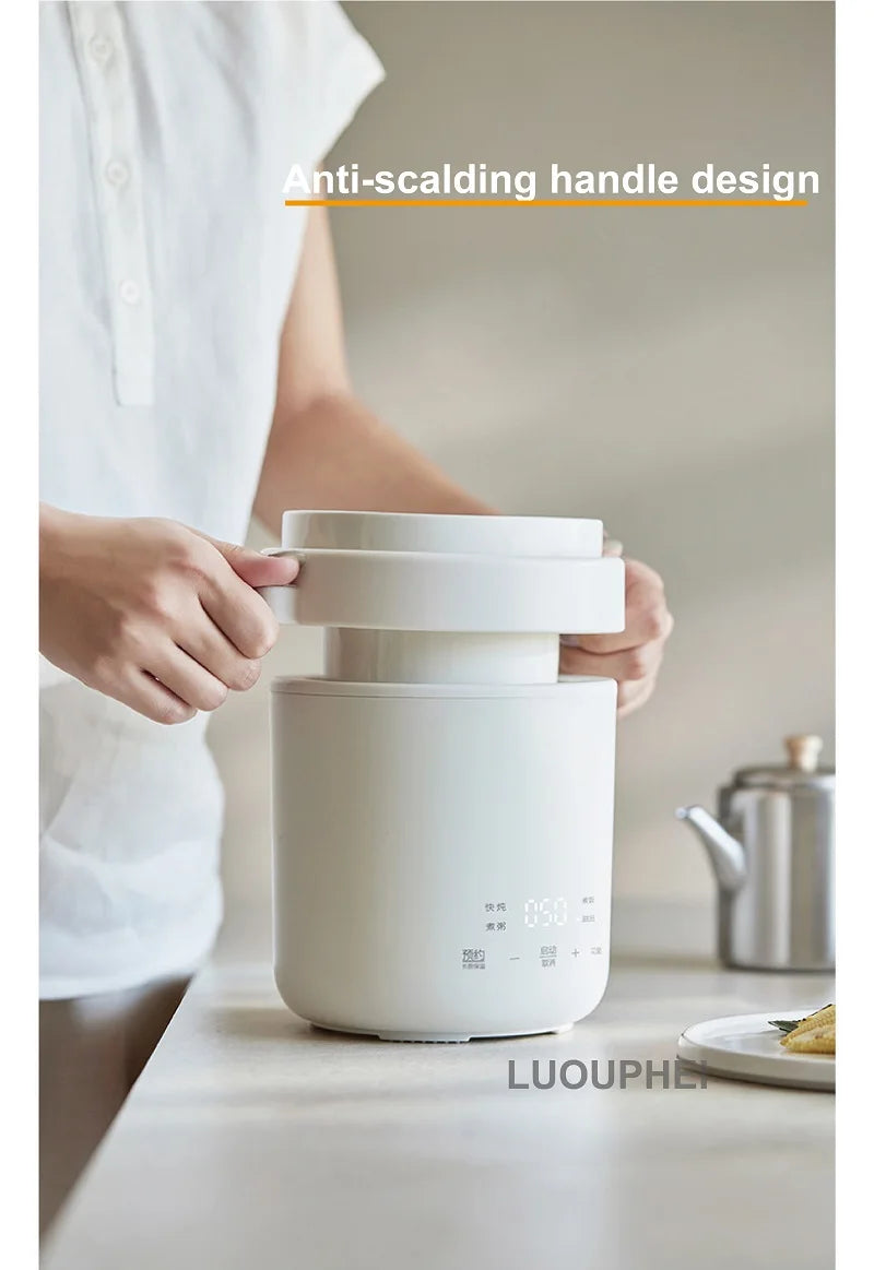 Hands holding a white mini electric rice cooker with insulated carry handles