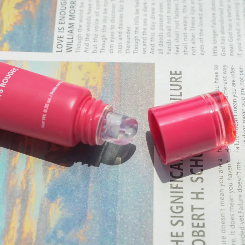 Laneige Lip Glowy Balm in pink tube with open cap, showing clear, glossy shea butter lip treatment texture.