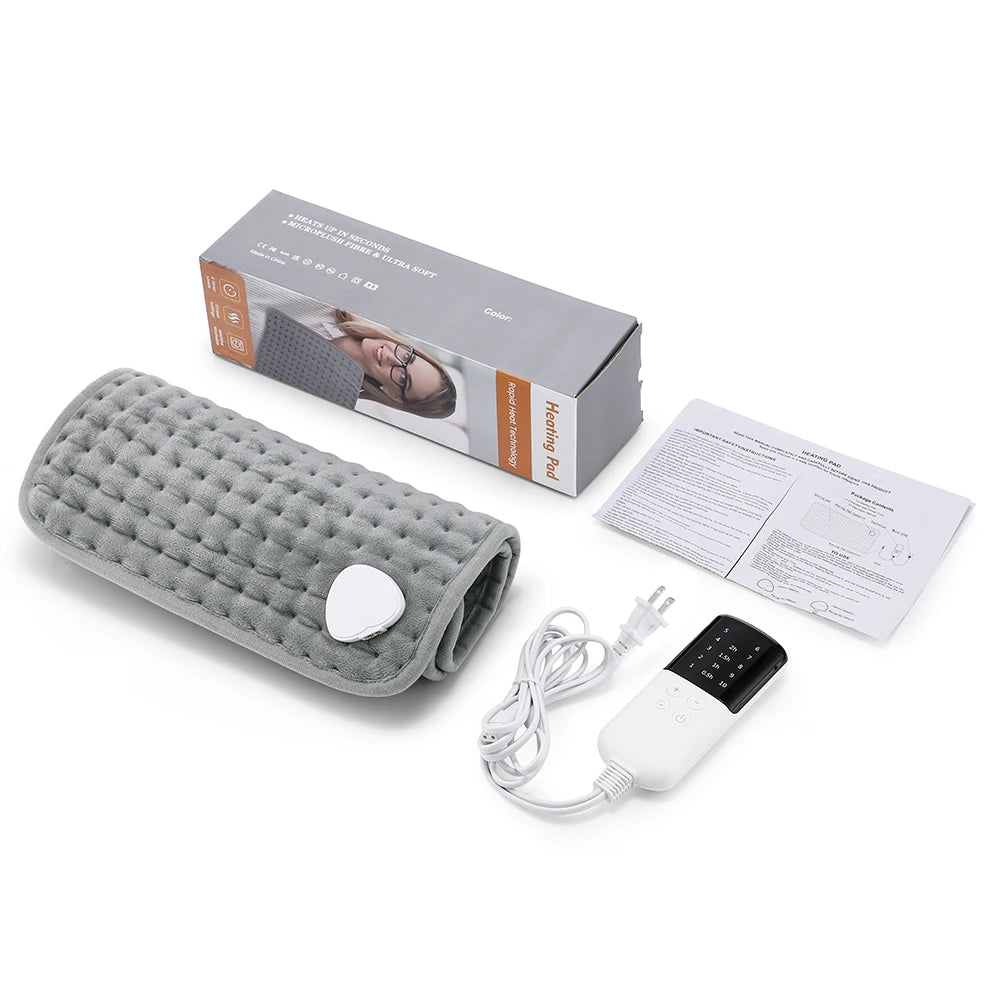 Gray quilted plush heating pad for pain relief, with a digital hand controller, manual, and product box.