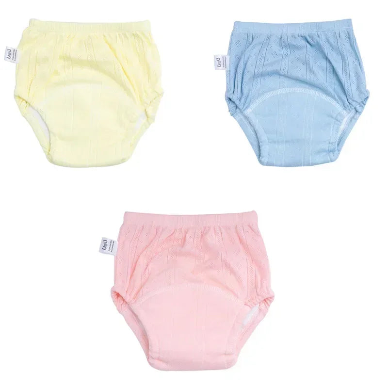 Set of 3 baby potty training diapers in pastel yellow, blue, and pink cotton. Breathable infant care diaper underwear.