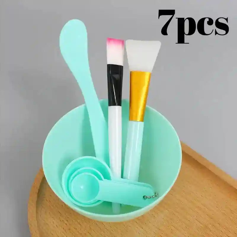 A 7-piece DIY facial mask kit featuring a mint green bowl, mixing spatula, brushes, and measuring spoons.