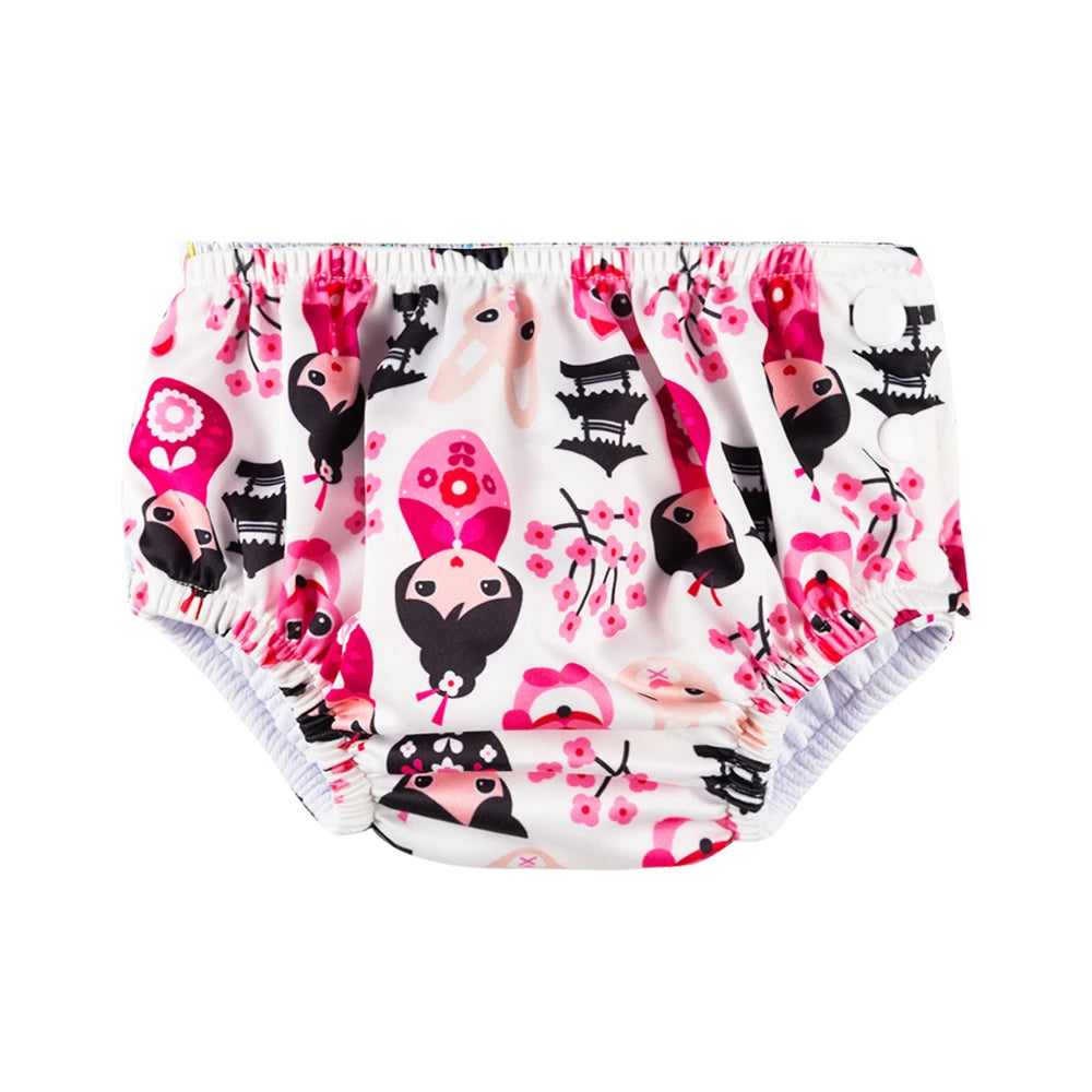 Reusable baby swim diaper with white and pink Japanese doll and cherry blossom print, adjustable snap closure.