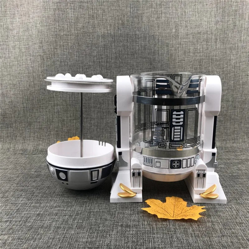 Star Wars R2-D2 glass and white plastic French press coffee maker with plunger lid and droid-themed design.
