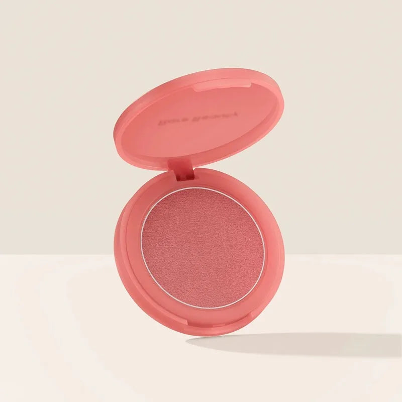 Rare Beauty powder blush in a soft pink compact, featuring a smooth, matte-finish pressed powder formula.