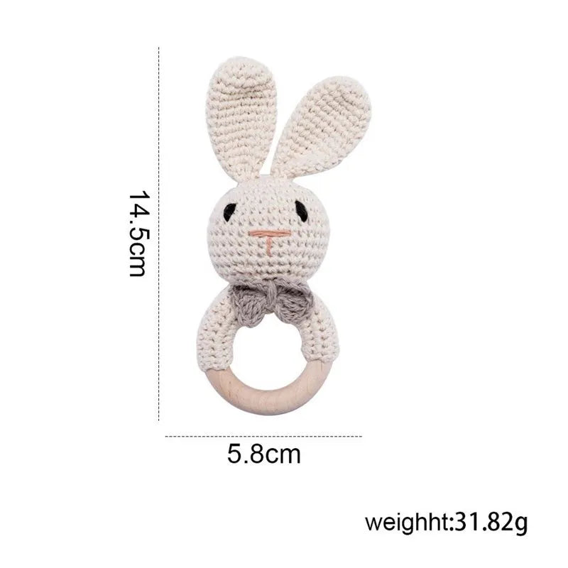 Beige bunny baby teething ring made of natural wood and cotton knit, perfect for teething relief.