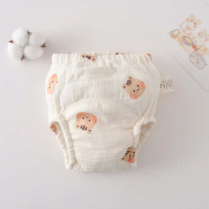 Reusable baby training diaper, size 80, in white cotton muslin with cute tiger face print. Comfortable baby care.