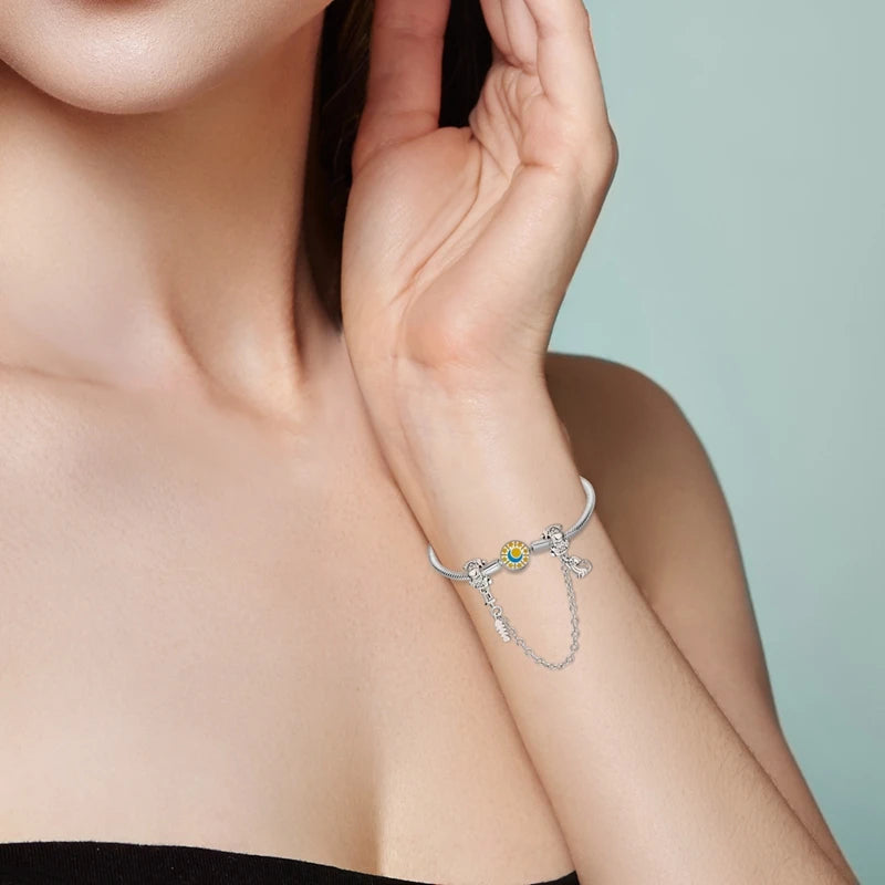 Woman wearing a 925 sterling silver dog charm bracelet, perfect for pet lovers and DIY personalized jewelry.