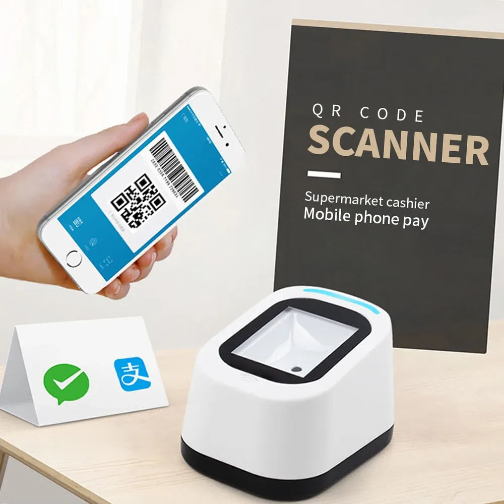 White wired QR code scanner on desk with hand holding phone QR code