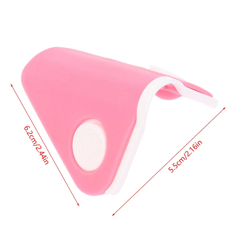 Pink silicone nose shaper lifting clip with white pads, facial beauty tool for bridge straightening and nose contouring.