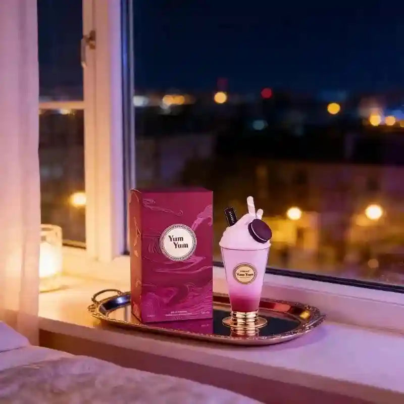 Yum Yum ombre pink candle shaped like a dessert in a glass, with a matching burgundy box on a gold tray.
