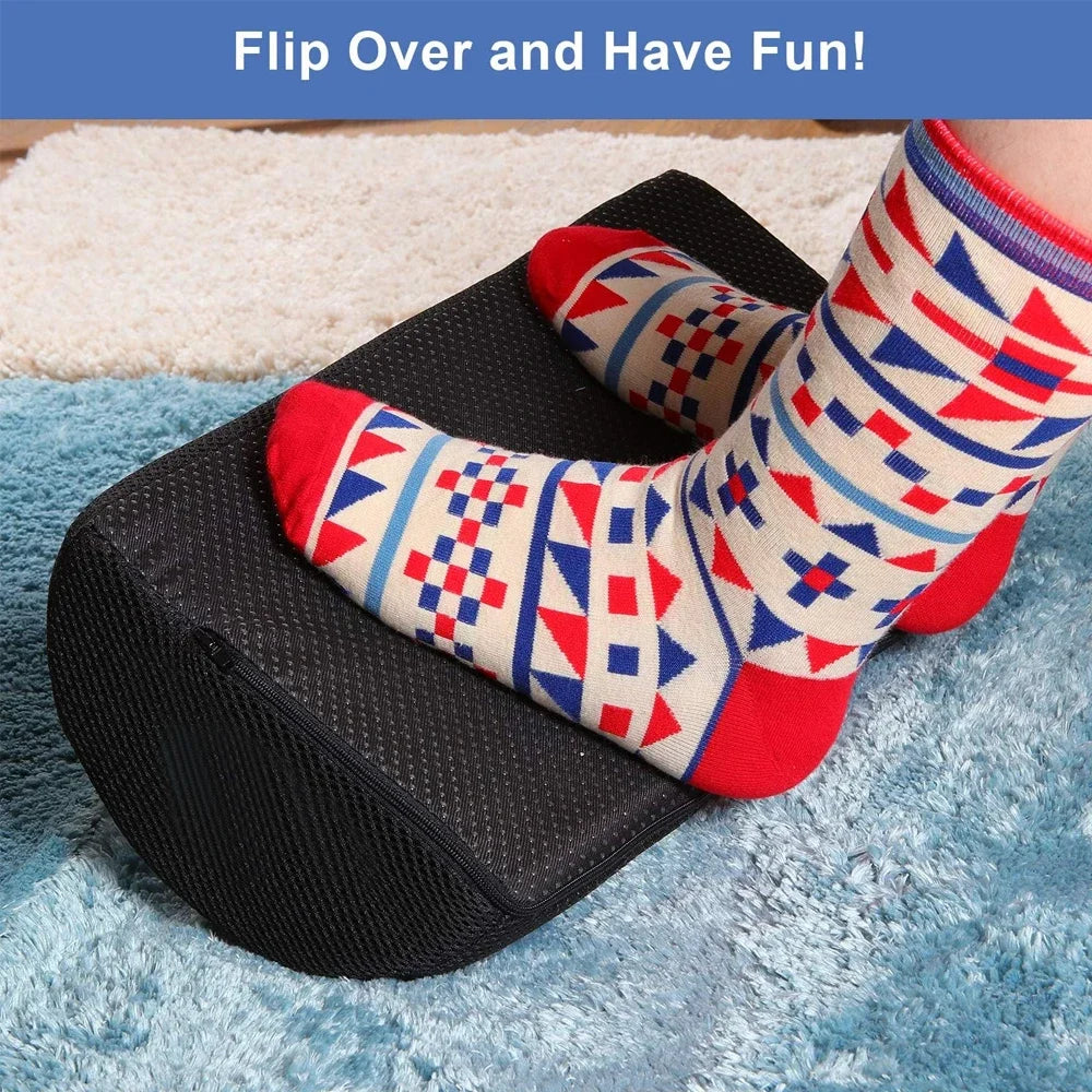 Ergonomic black memory foam foot rest for under desk, featuring non-slip beaded base for office or home comfort.