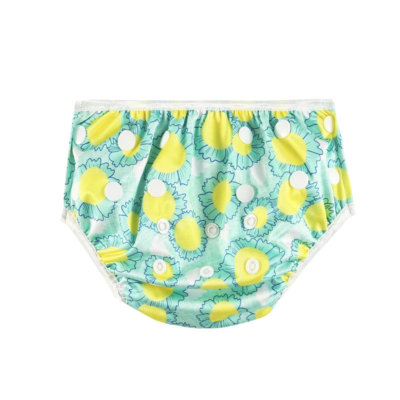 Reusable baby cloth diaper cover with adjustable snaps, featuring a yellow and teal sunflower floral print pattern.