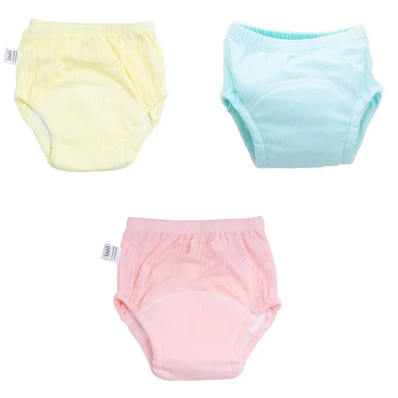 Set of 3 pastel-colored baby training pants diapers in yellow, mint, and pink with a soft, breathable fabric design.