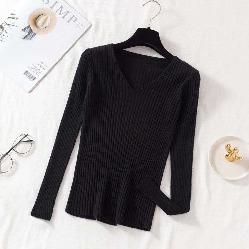 Tidesmit black ribbed knit long sleeve sweater featuring a classic V-neckline, hanging on a black hanger.