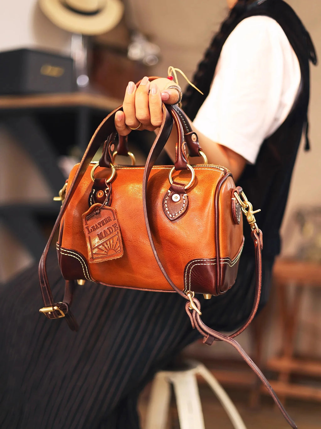 PNDME vintage handmade genuine cowhide small leather handbag in tan and brown with brass hardware and crossbody strap.